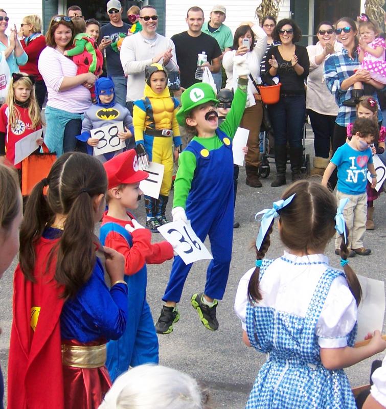 Xavier Montero celebrates after winning first place in the costume contest along with Carmine August. The duo dressed as video game characters Mario and Luigi. BY MATTHEW BERNAT